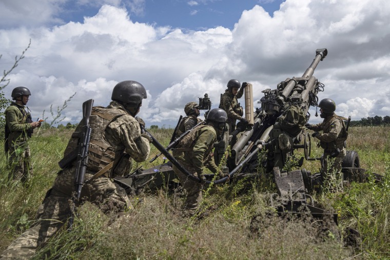 Ukrainian servicemen prepare to fire at Russian positions in Kharkiv, Ukraine