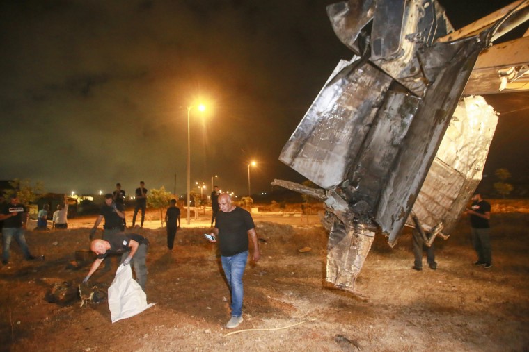 Israeli authorities in Rahat inspect the remains of what the military said is a Syrian anti-aircraft rocket that exploded in the air on July 2, 2023.