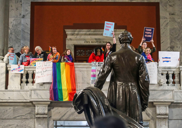 Behind a statue of Abraham Lincoln, demonstrators rally in the Kentucky capitol rotunda to oppose SB 150, a bill that would ban gender-affirming care for trans youth, on March 29, 2023.