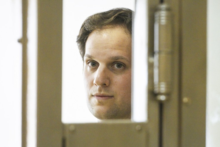 Wall Street Journal reporter Evan Gershkovich stands in a glass cage in a courtroom in Moscow on June 22, 2023.
