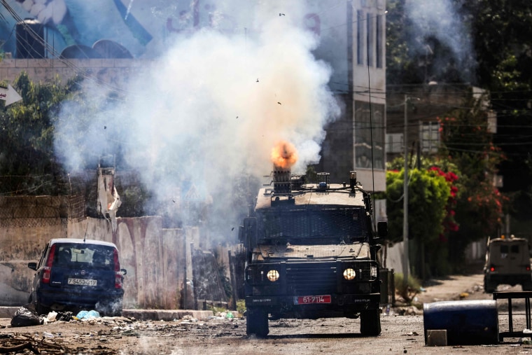 Israel's biggest military operation for years in the occupied West Bank continued for a second day on July 4, leaving at least 10 Palestinians dead and forcing thousands to flee their homes as the government said it struck "with great strength" the militant stronghold.