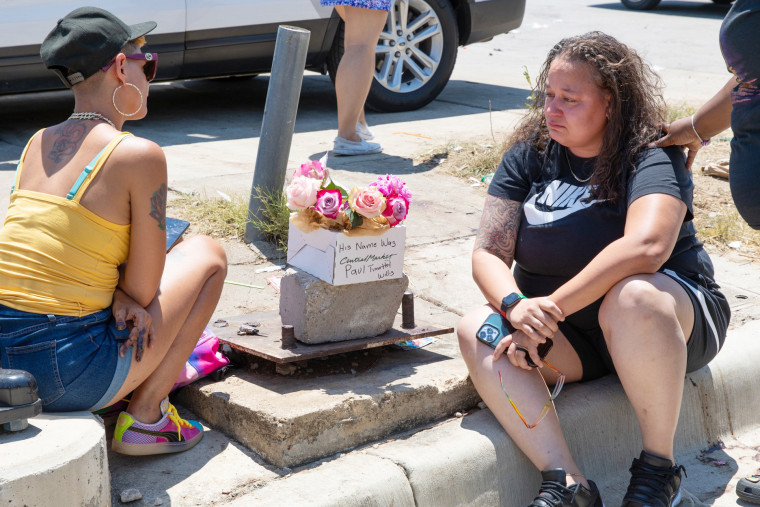 People mourn victims near the site of a shooting in Fort Worth, Texas, on July 4, 2023.