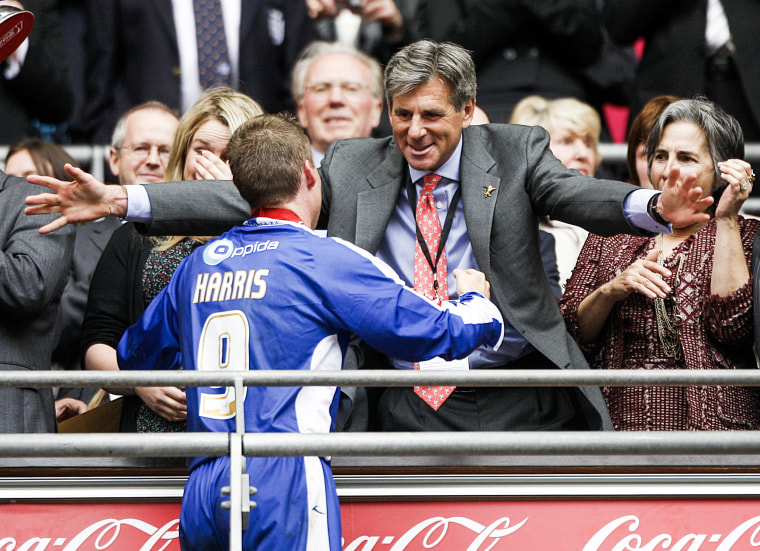 Millwall chairman John Berylson  hugs Neil Harris in London on May 29, 2010.
