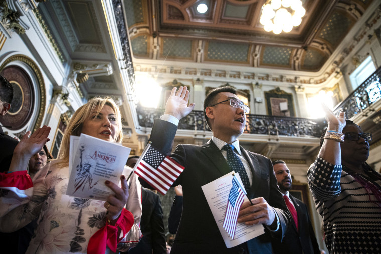 Candidates take the Oath of Allegiance to become US citizens during a naturalization ceremony at the Eisenhower Executive Office Building in Washington