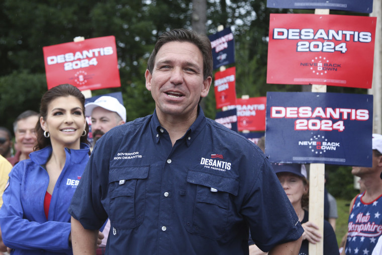 Republican presidential candidate and Florida Gov. Ron DeSantis and his wife Casey, walk in the July 4th parade, Tuesday, July 4, 2023, in Merrimack, N.H.