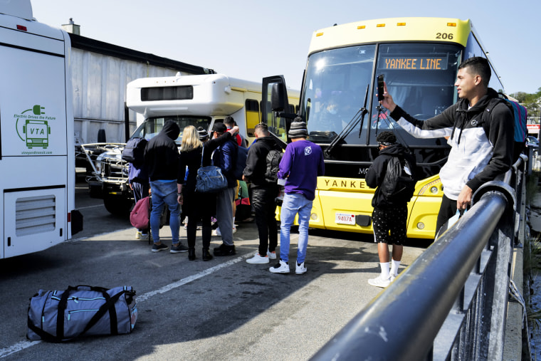 Venezuelan migrants gather at the Vineyard Haven ferry terminal in Martha's Vineyard, Mass.
