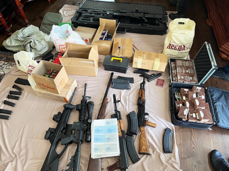 Assault rifles and ammunition are arranged on the floor of Prigozhin's home. 