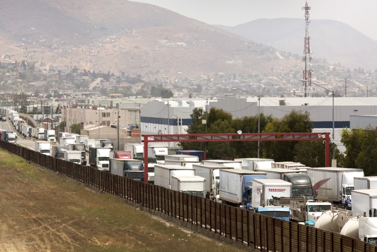 A long line of tractor trailers await entry into the U.S. from Mexico at the Otay Mesa, Calif., port of entry, June 22, 2016.