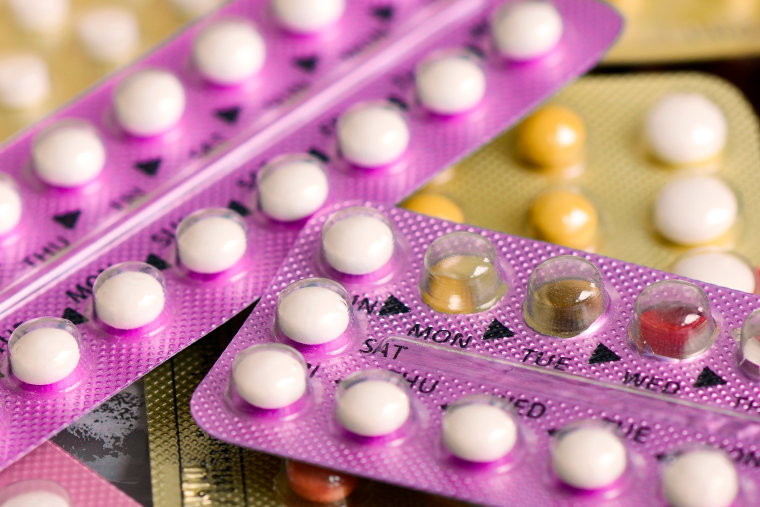 Oral contraceptive pills on pharmacy counter.