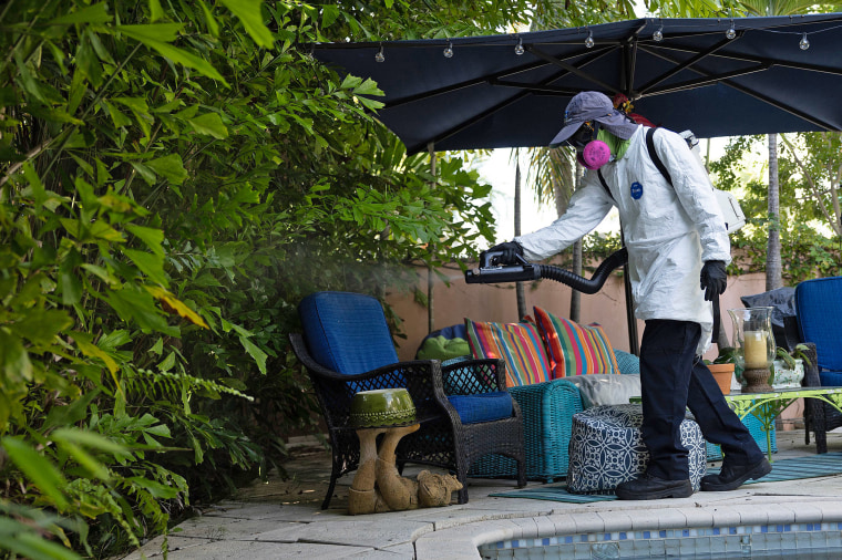 A Miami-Dade Mosquito Control Inspector sprays pesticide to kill adult mosquitos on June 29, 2023.