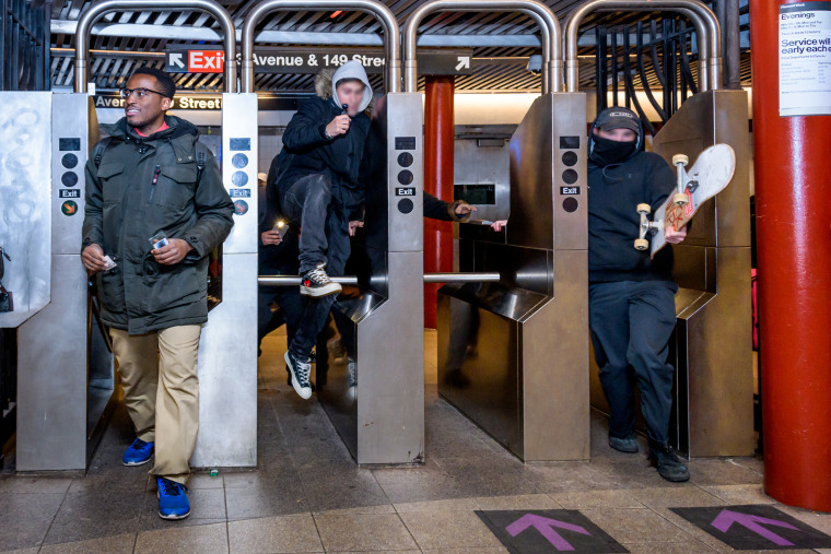 A man jumps the turnstile at a subway station, in New York City
