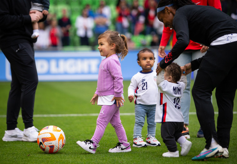 The children of Alex Morgan, Crystal Dunn, and Adrianna Franch play with the ball after after a soccer match