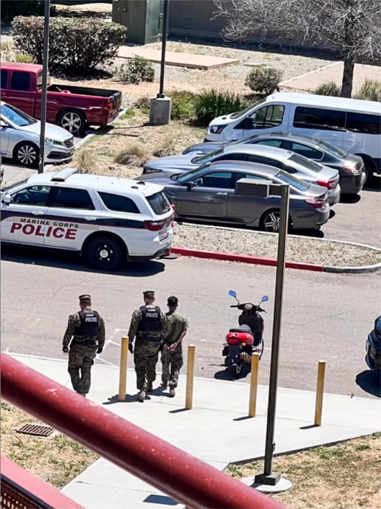 Police take a Marine into custody on June 28, 2023, at Camp Pendleton in Oceanside, Calif., in connection with a teen who was missing for 15 days.