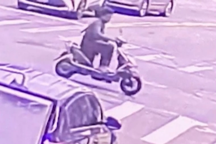 Footage from a security camera shows a man on a scooter who was later taken into custody after allegedly killing one person and injuring three others with a gun on July 8, 2023.