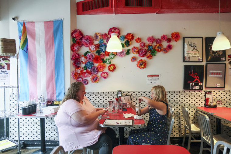 Jennilyn, left, and Flower Nichols, an 11-year-old transgender girl, eat at a restaurant during a visit to Chicago on June 13, 2023.