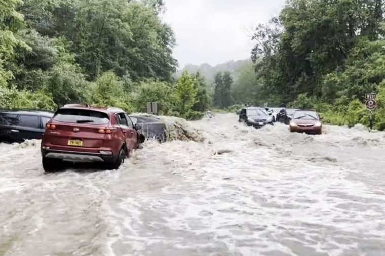 Cars were stranded by floodwaters Sunday near Woodbury and Harriman in Orange County, New York.