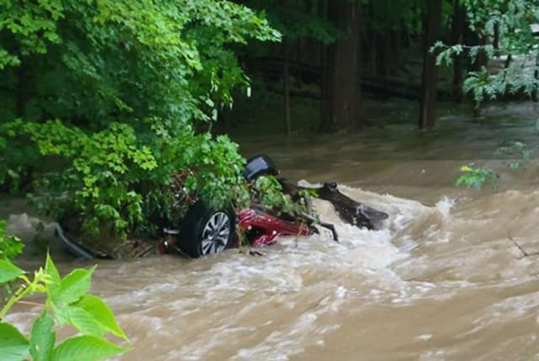 An overturned vehicle in floodwaters in Port Jervis, N.Y., on Sunday.