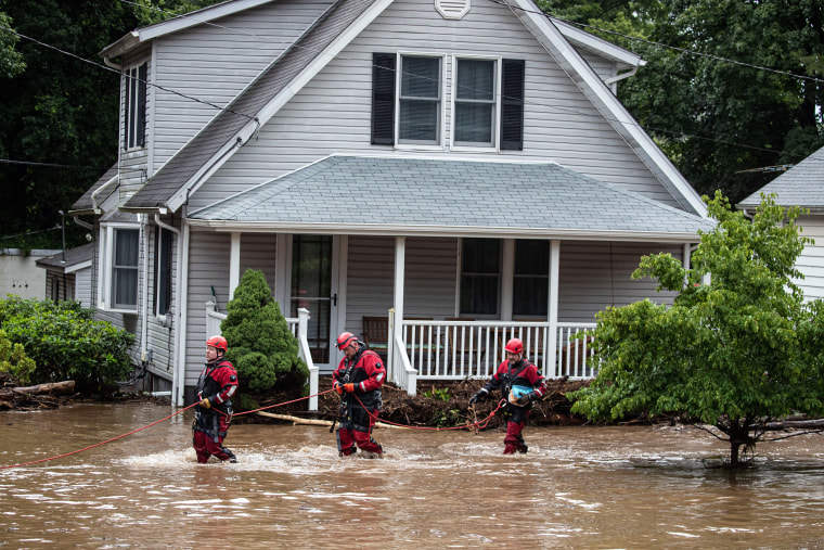 Emergency personnel work at the scene of flooded homes in Stony Point, N.Y.