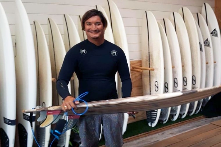 Mikala Jones at Surf Ranch in Lemoore, Calif., in 2019 with a surfboard his brother Daniel Jones made.