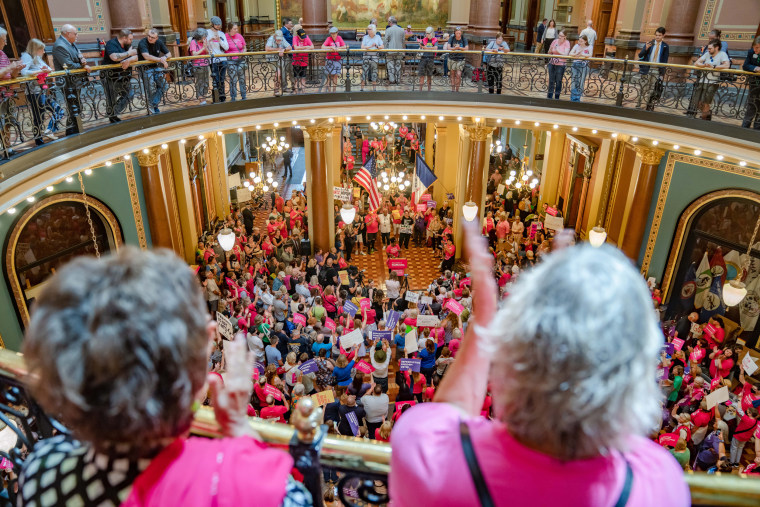 Protesters rally for reproductive rights in the Iowa State Capitol rotunda on July 11, 2023.
