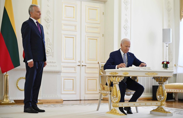 Biden signs guestbook at Lithuanian presidential palace