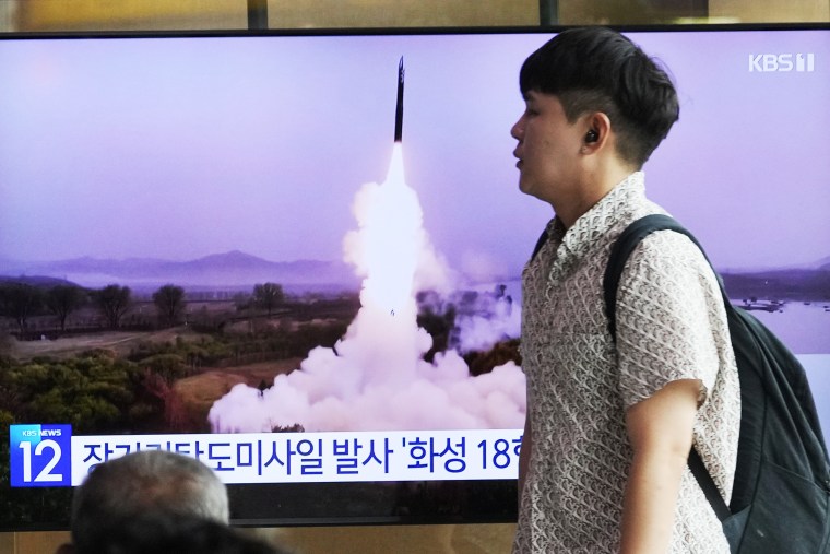 A news broadcast at a railway station in Seoul, South Korea, on Wednesday shows file footage of a North Korean missile test.