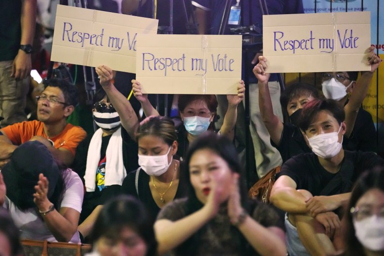 Supporters of Move Forward Party hold posters during a protest in Bangkok on July 12, 2023. 