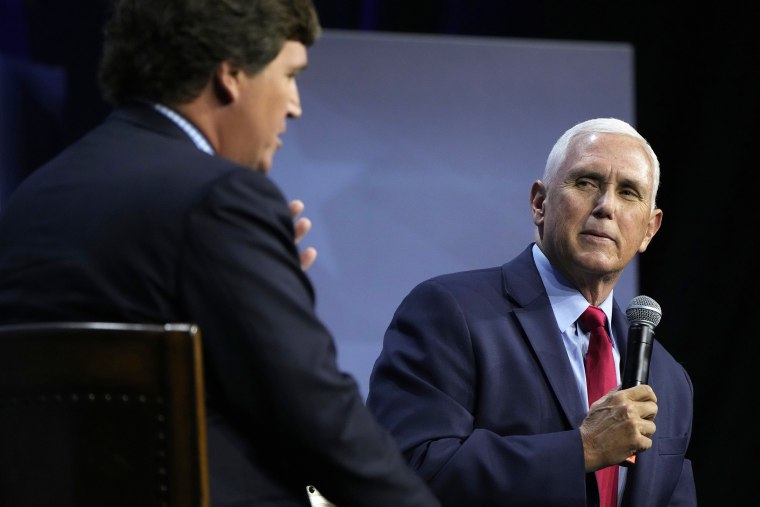 Republican presidential candidate former Vice President Mike Pence talks with moderator Tucker Carlson, left, during the Family Leadership Summit, Friday, July 14, 2023, in Des Moines, Iowa.