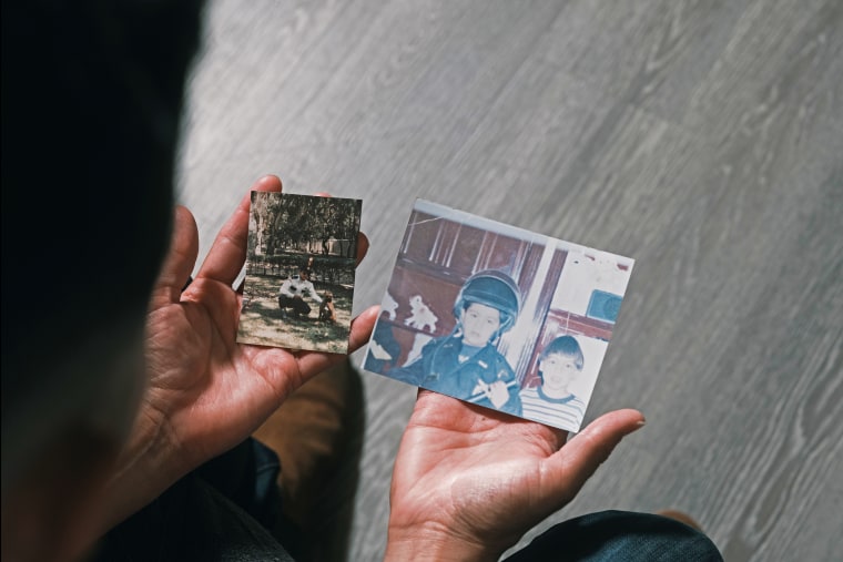 Christian Mendoza holds a picture of his father in Mexico and a picture of himself wearing his father’s police uniform.