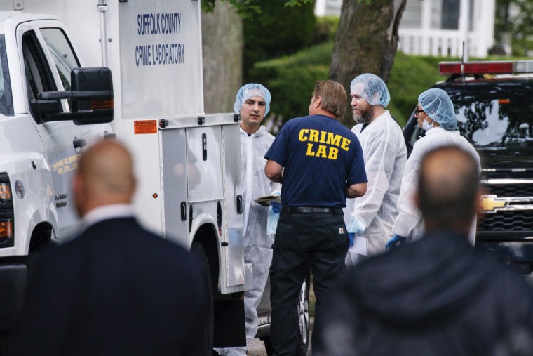 Crime lab officers arrive at the house where a suspect has been taken into custody on New York's Long Island in connection with a long-unsolved string of killings, on Friday, July 14, 2023, in Massapequa Park.