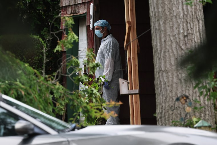 Law enforcement officials investigate the home of a suspect arrested in the Gilgo Beach killings on July 14, 2023 in Massapequa Park, N.Y.