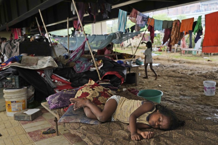 In New Delhi, residential areas close to the Yamuna River were flooded, submerging roads, cars and homes, leading to the evacuation of thousands of people from low-lying areas. Dozens of cars were blocked by sheets of water throwing movement of vehicles into disarray during the morning rush hour in New Delhi on Thursday. 