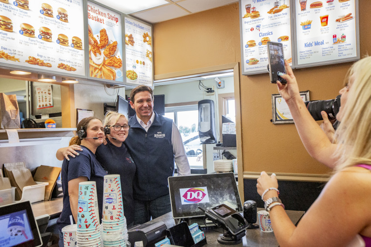 Ron DeSantis, governor of Florida, right, takes a photo with workers at Dairy Queen while campaigning in Boone, Iowa, US, on Friday, July 14, 2023. The Federal Election Commission report due Saturday for the second quarter of 2023 will give indications how effectively DeSantis is reaching average people who donate small amounts, a proxy of grassroots support. Photographer: Rachel Mummey/Bloomberg via Getty Images
