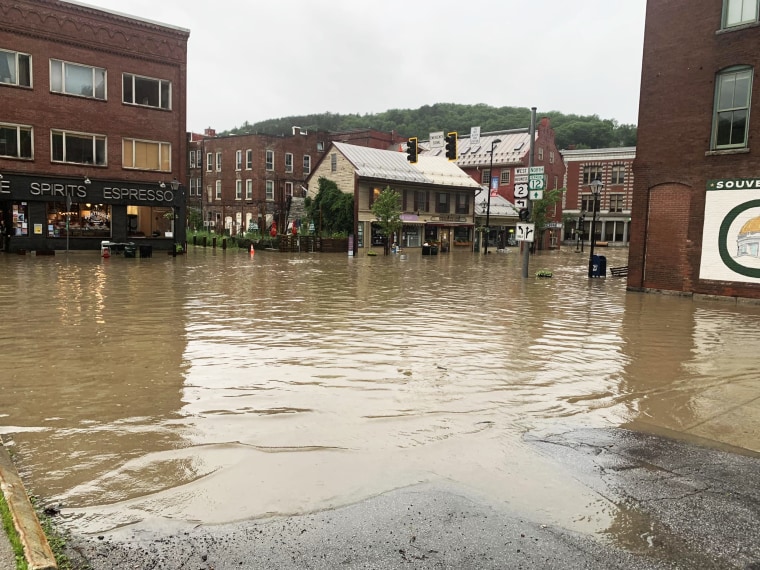 Water floods the streets in Montpelier, Vt.