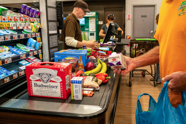 Customers checkout at a supermarket in Burlington, Vt., on June 16, 2023.