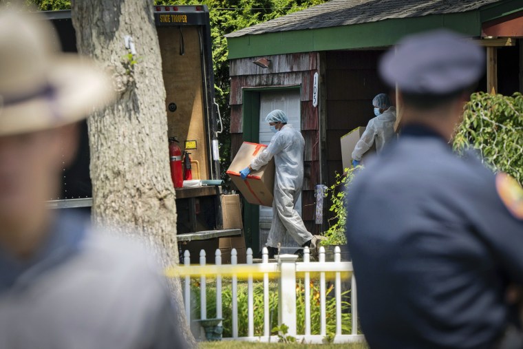 Crime lab officers removes boxes from the home of Rex Heuermann on July 15, 2023, in Massapequa Park, N.Y. 