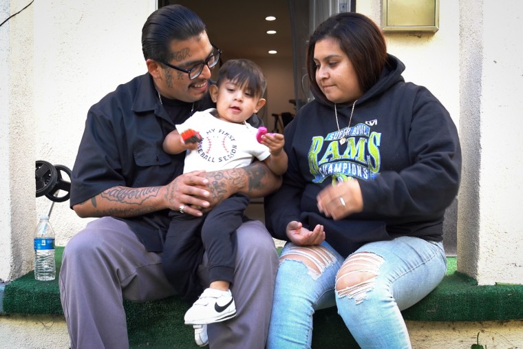 Jose Ruiz with his young son and his girlfriend at his mother's house.  