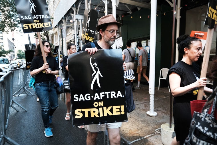 Members of the actors SAG-AFTRA union walk a picket line with screenwriters outside of Netflix's New York office on the first day of the actors' strike on July 14, 2023 in New York City. Members of SAG-AFTRA, Hollywoodâ€™s largest union which represents actors and other media professionals, joined striking WGA (Writers Guild of America) workers in the first joint walkout against the studios since 1960. The strike could shut down film productions completely with writers in the third month of their strike against the Hollywood studios.