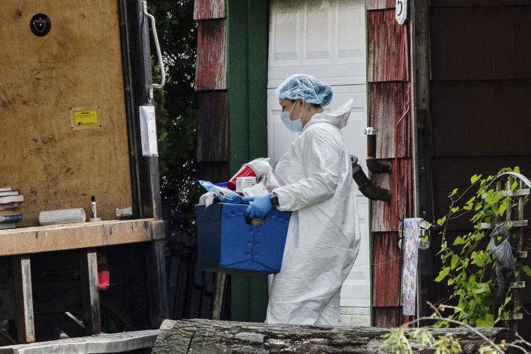 A crime lab officer removes a box from the home of Rex Heuermann on July 15, 2023, in Massapequa Park, N.Y. 
