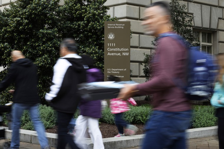 Tourists walk past the headquarters of the Internal Revenue Service in Washington, D.C.