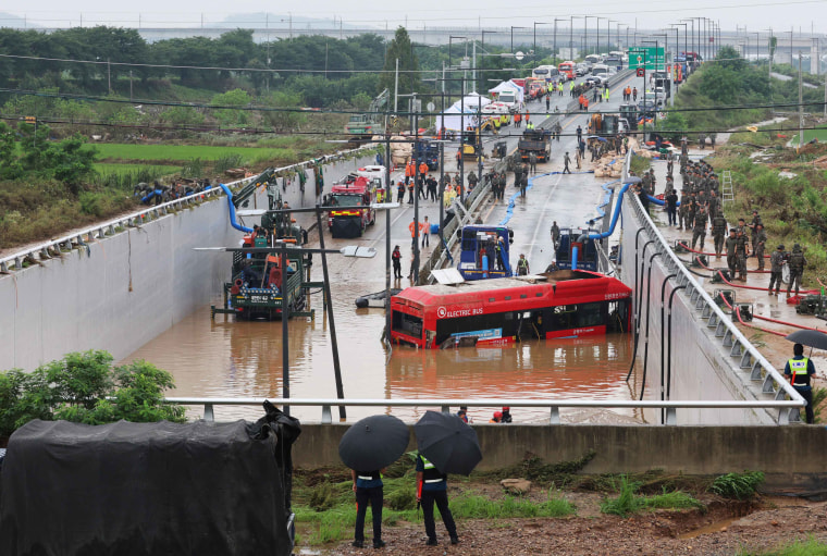 Rescuers battled to reach people trapped in a flooded tunnel Sunday in South Korea, where at least 33 people have died and 10 are missing after heavy rains caused flooding and landslides. 