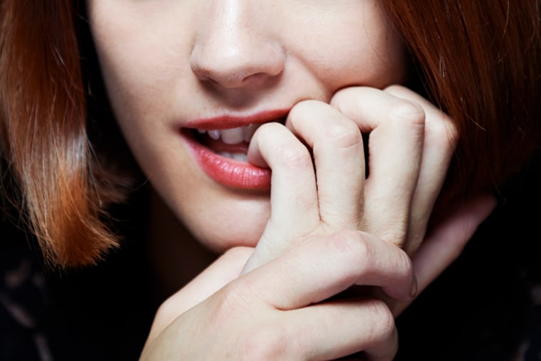 woman biting nails