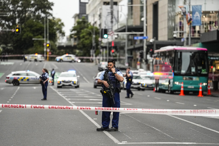 Image: Armed New Zealand police officers stand at a road block in the central business district following a shooting in Auckland, New Zealand, on July 20, 2023.