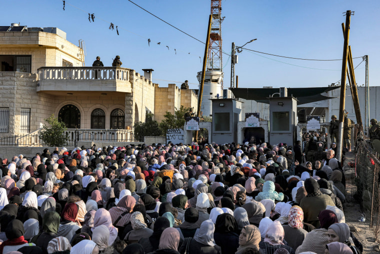 Palestinians queue at an Israeli checkpoint in Bethlehem