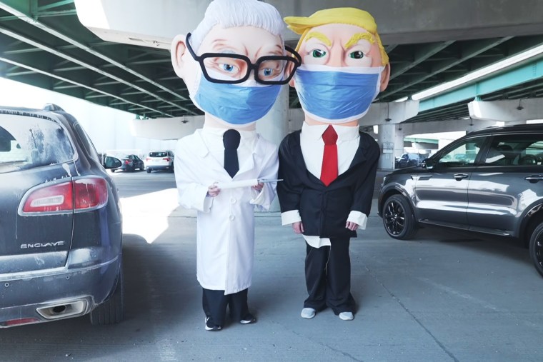 DeSantis super PAC staffer trolls Trump town hall with Fauci and Trump mascots.