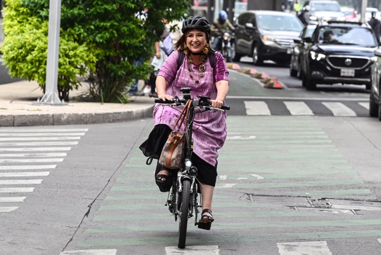 Image: Former Mexican Senator Xóchitl Gálvez arrives by bicycle before registering as a presidential pre-candidate for the Frente Amplio por Mexico party in Mexico City on July 4, 2023.