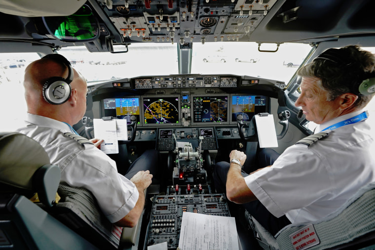 American Airlines pilot captain Pete Gamble, left, and first officer John Konstanzer conduct a pre-flight check in before taking off from Dallas Fort Worth airport in Grapevine, Texas