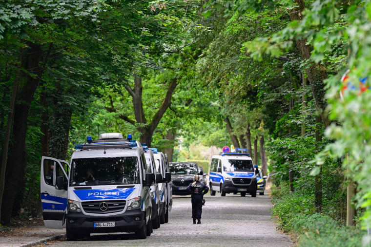 Police officers take part in the search for a lion on the loose in Stahnddorf, Germany