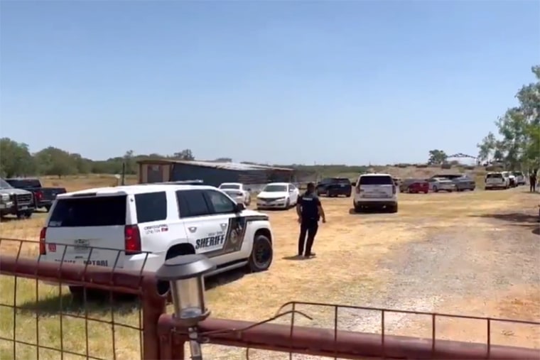 A Bexar County Sheriff's officer secures the scene at a Texas ranch on July 20, 2023.