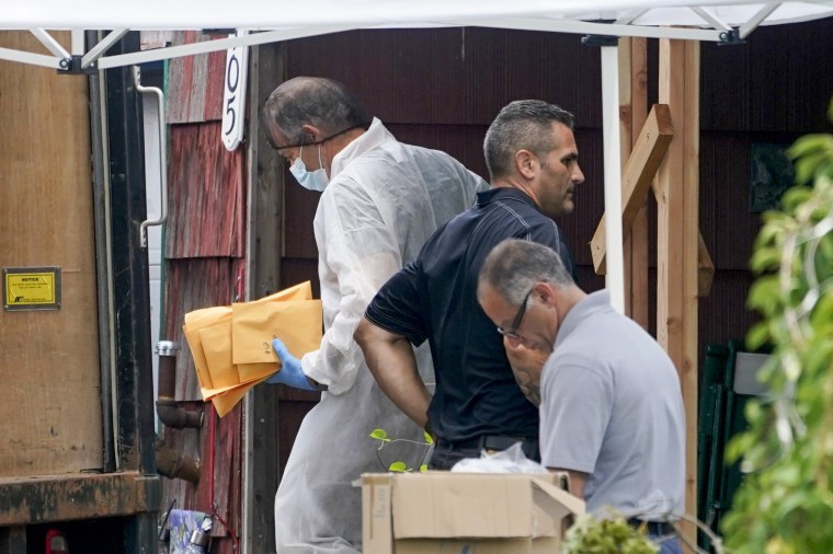 Authorities remove evidence as they search the home of suspect Rex Heuermann on July 18, 2023, in Massapequa Park, N.Y. 